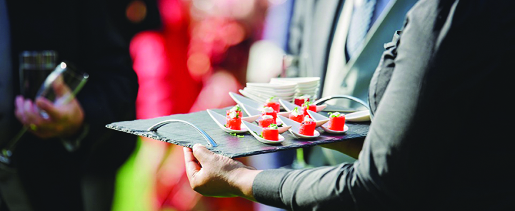 A photograph of a person holding a tray of food.