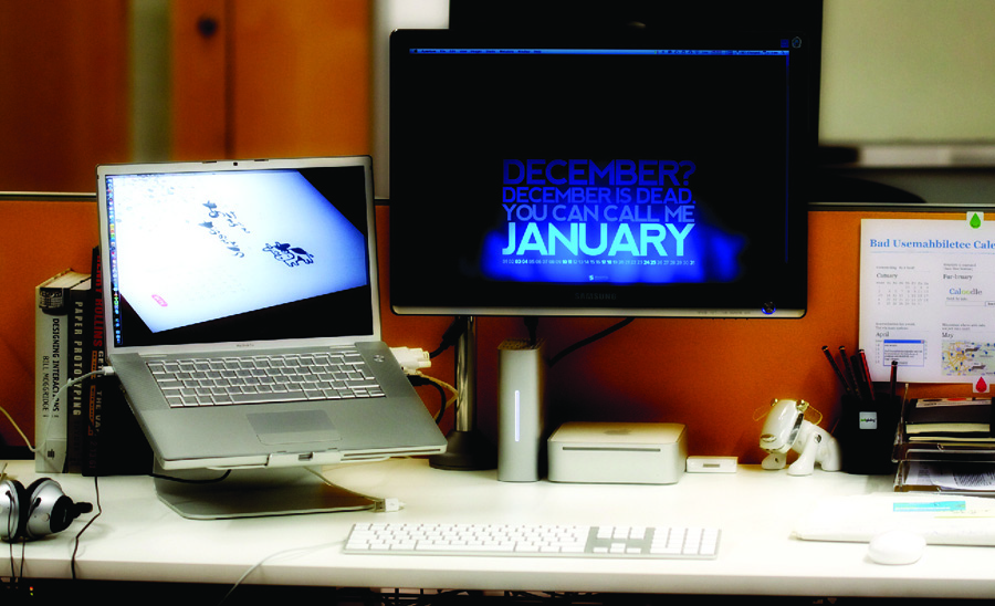 Photo of a laptop and separate monitor on a desk.